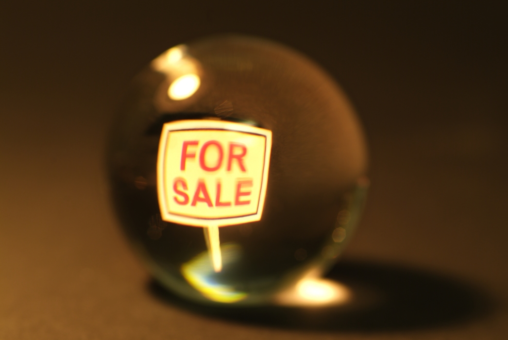 Crystal Ball with Real Estate For Sale Sign Inside