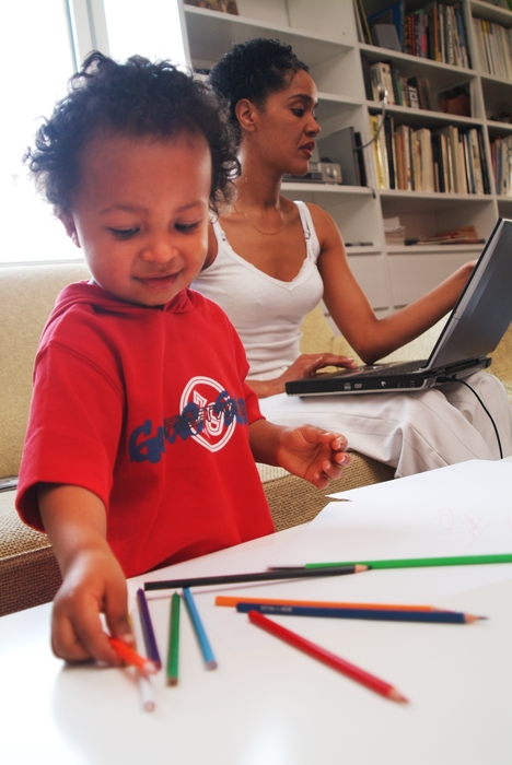 Boy Playing While Mother Works