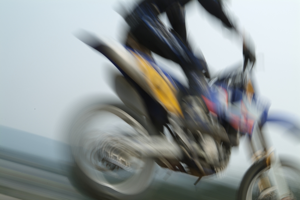 Motocross Racing Racer Lands from Jump
