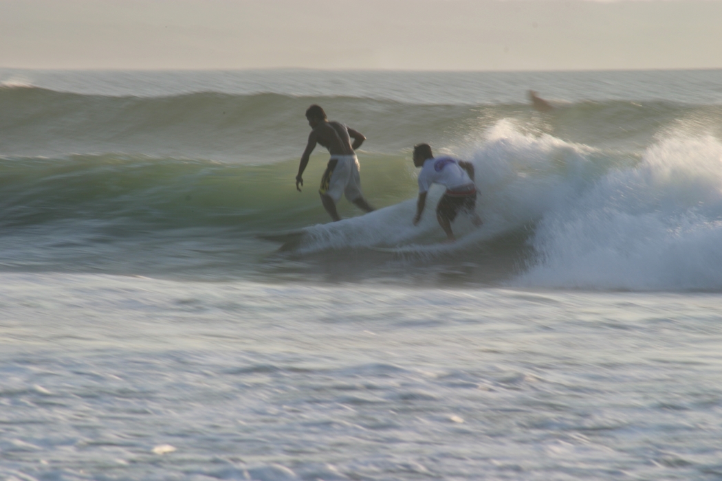 Surfers Riding a Wave