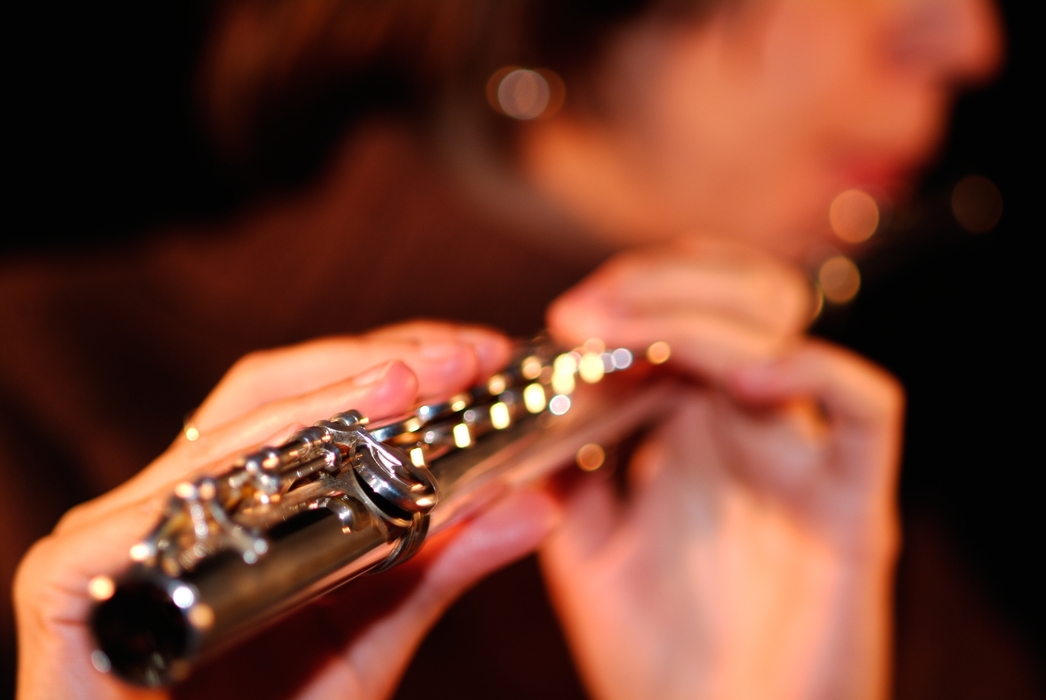 Concert Flutist in the Orchestra Plays