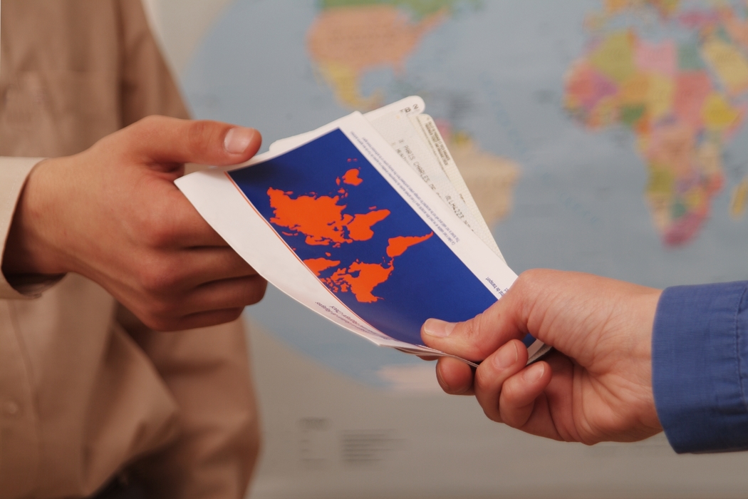 Businessman Receiving Travel Tickets