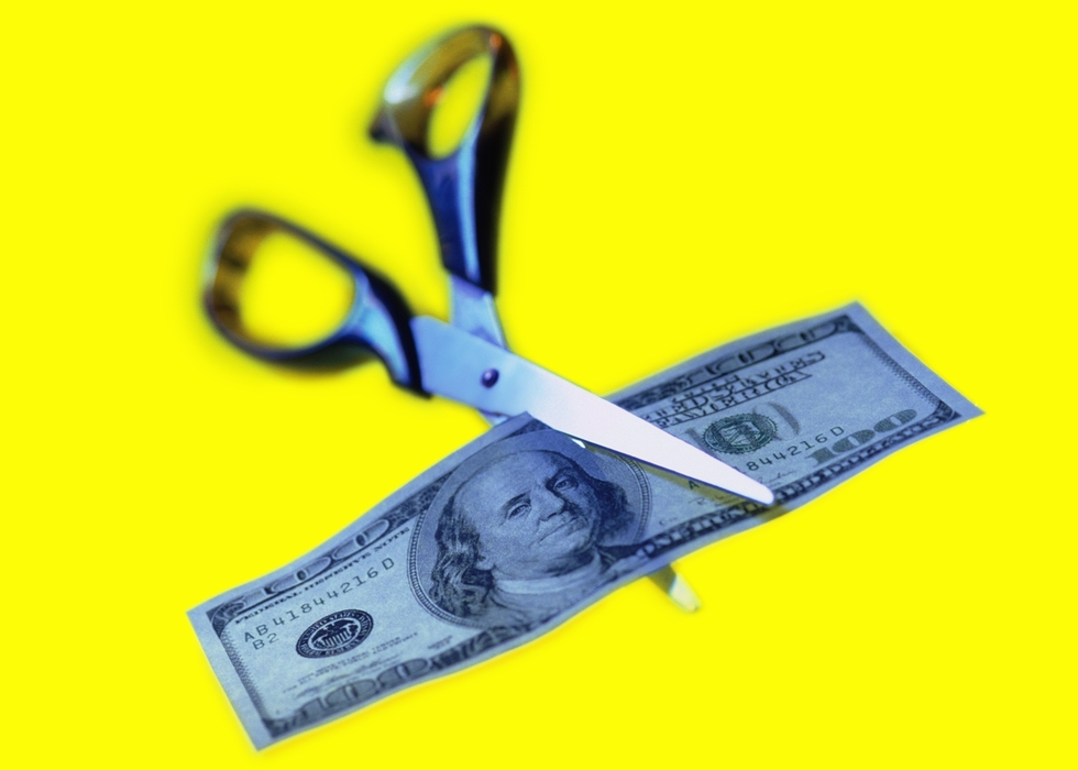 Scissors Cutting a Dollar Bill in Half