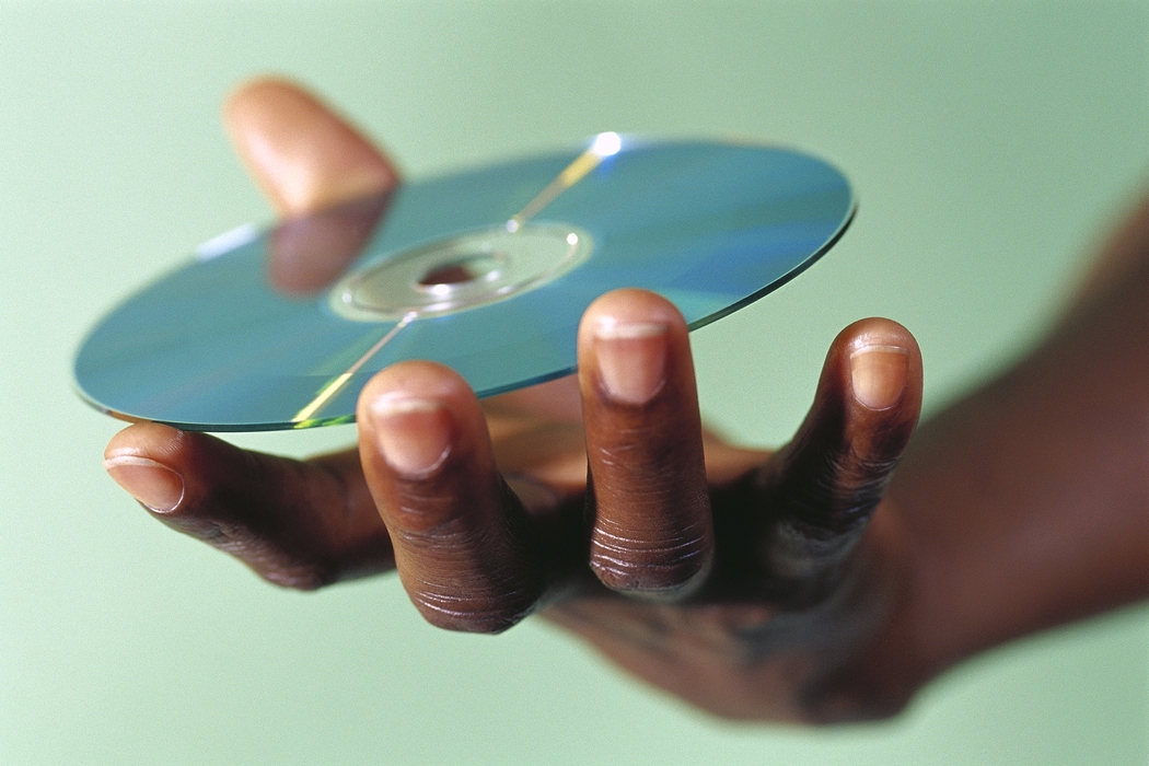 Hand Holding a CD-ROM