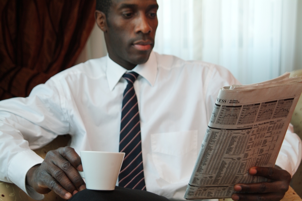 Man Reading Paper & Having Coffee