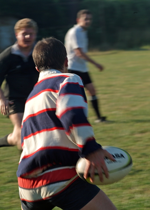 Rugby Player Passes the Ball