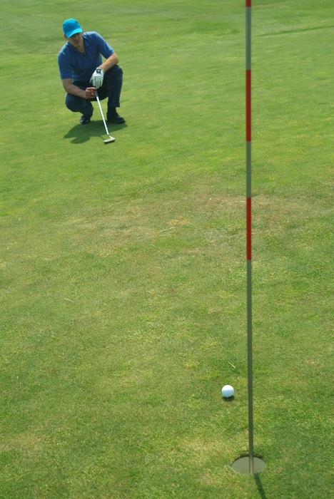 Golfer Lining Up Putt