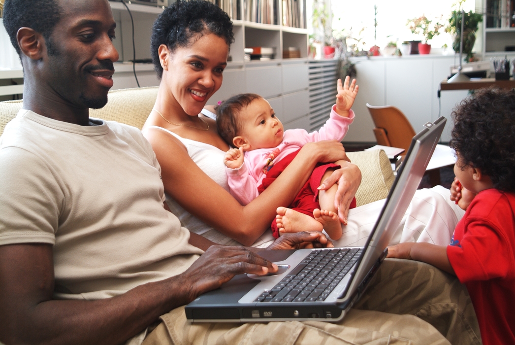 Family Relaxing At Home While Father Works