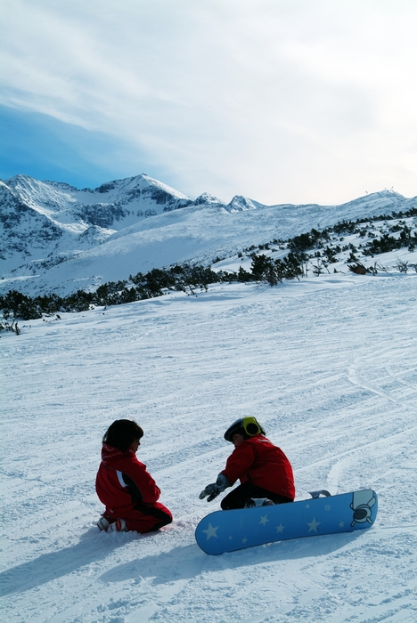 Young Snowboarders Discussing Plans to Conquer the Mountain