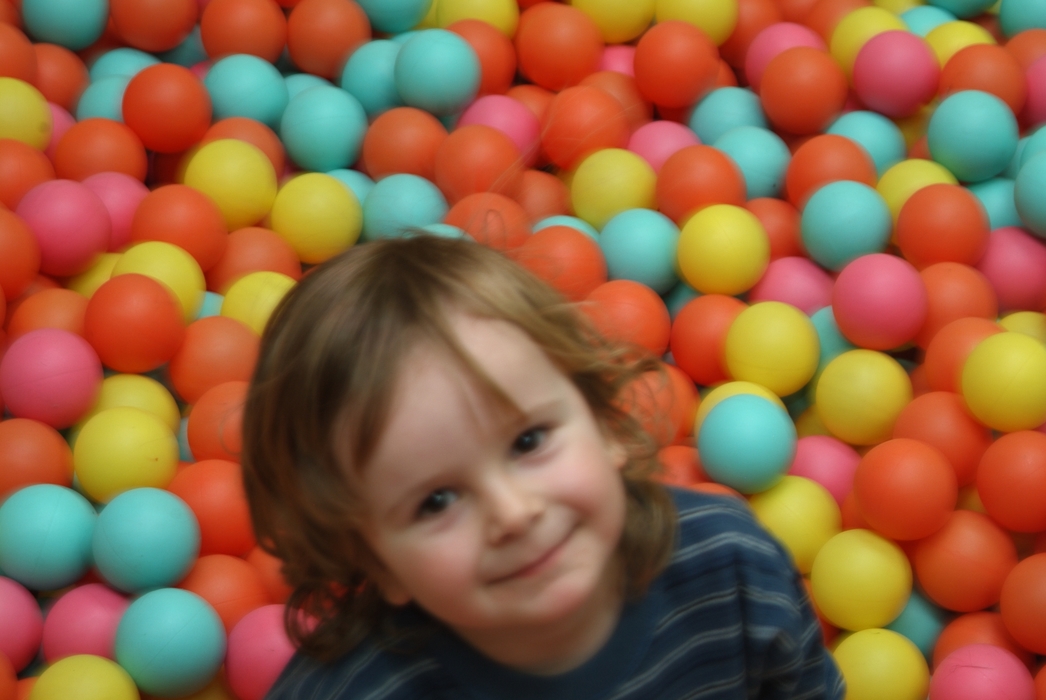 Boy Playing in Ball Room