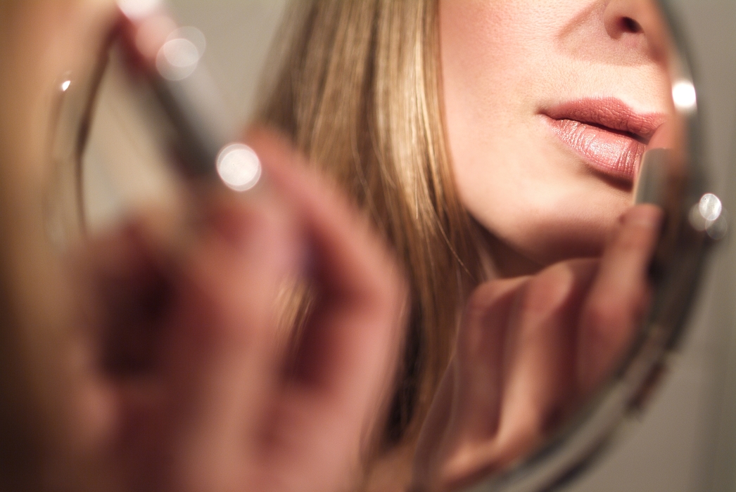 Woman Applying Her Lipstick