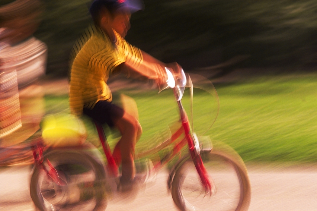 Boy Riding Bike in Park