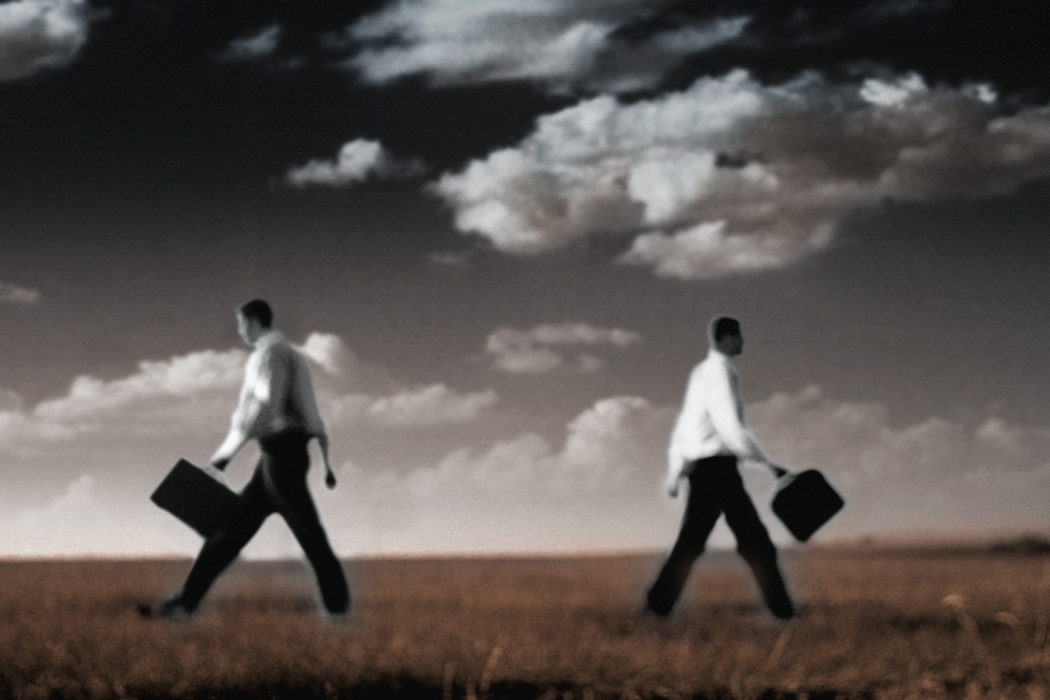 Businessmen Walking in Opposite Directions