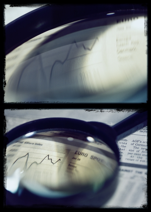 Magnifying Glass Looking At Charts