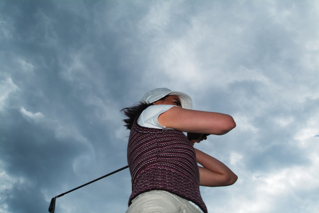 Female Golfer Watching Shot