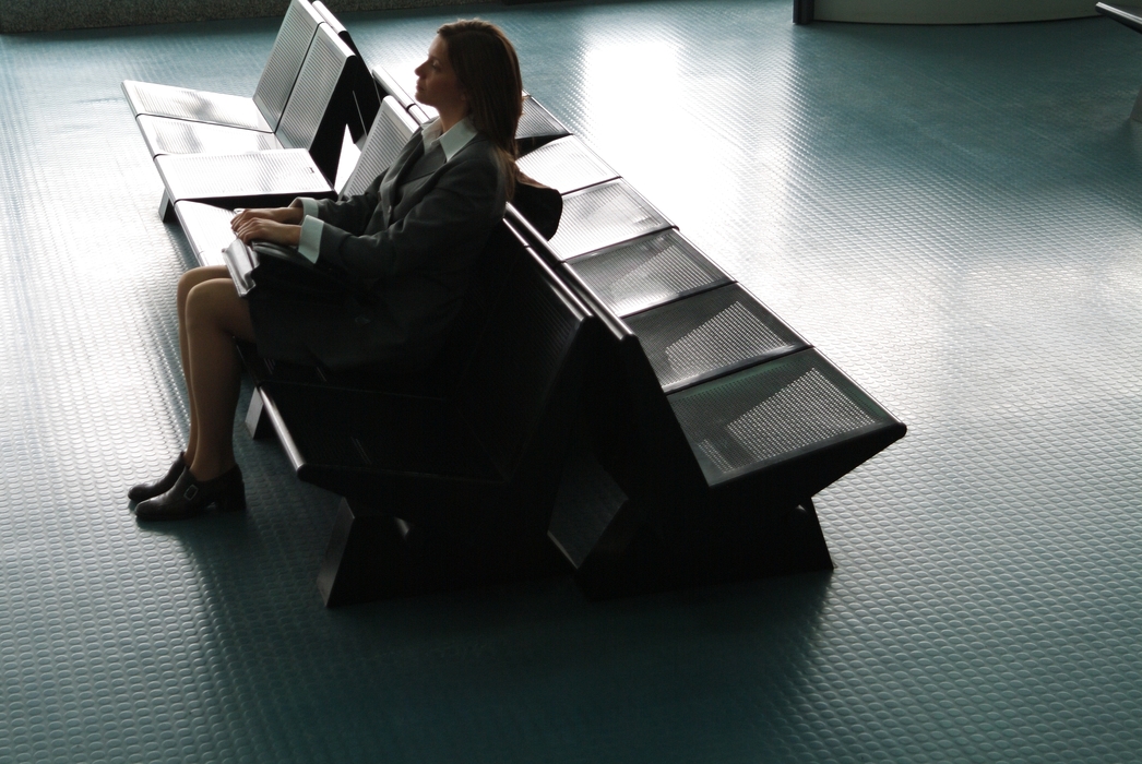 Woman Waiting in Airport Terminal