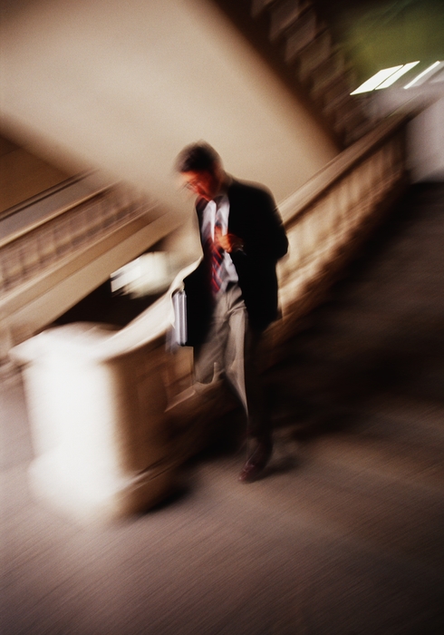 Businessman Running Up Stairs