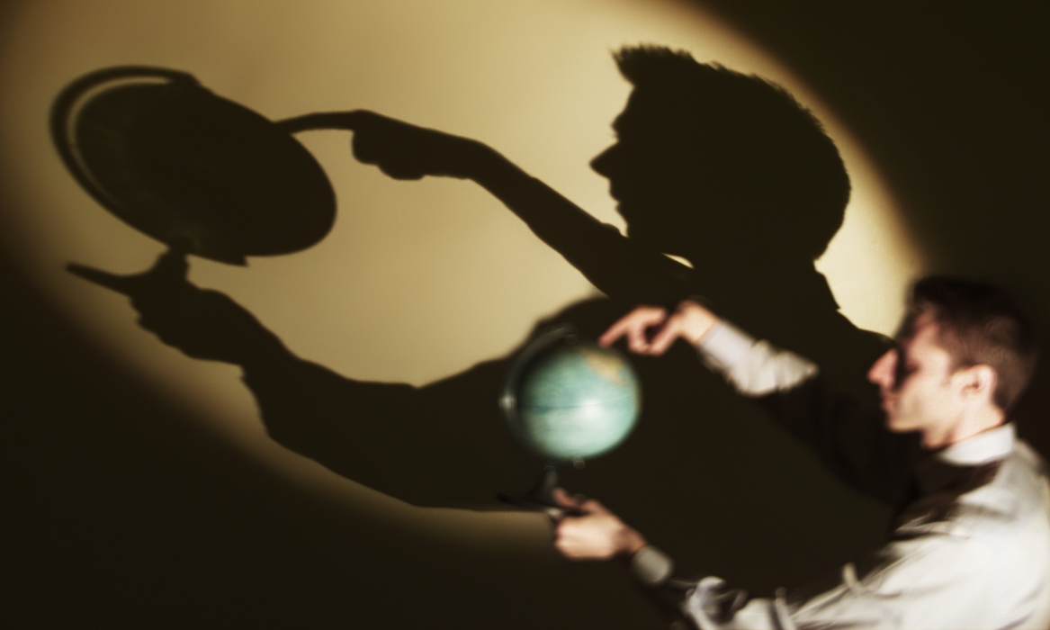 Businessman Spinning a Globe with Shadow