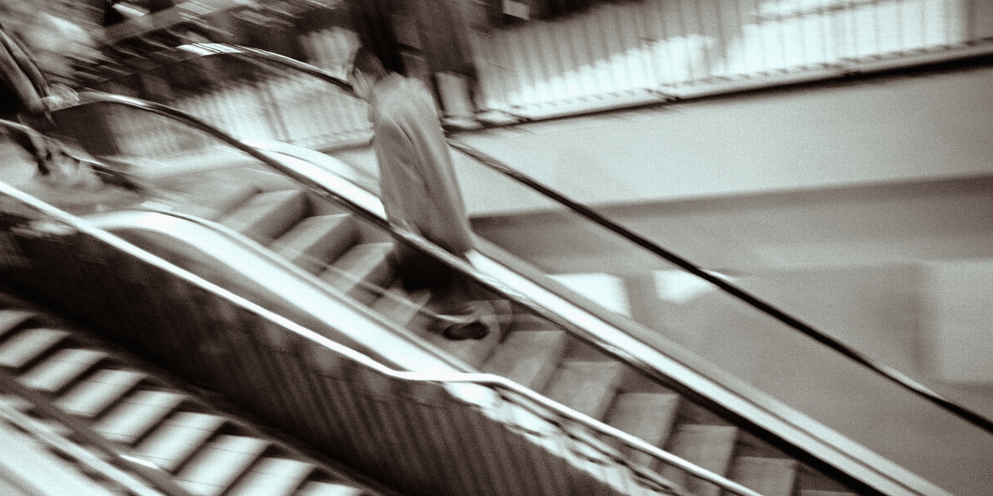 People Going Down An Escalator