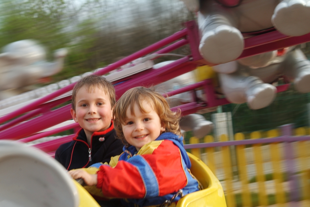 Children on a Ride At The Amusement Park