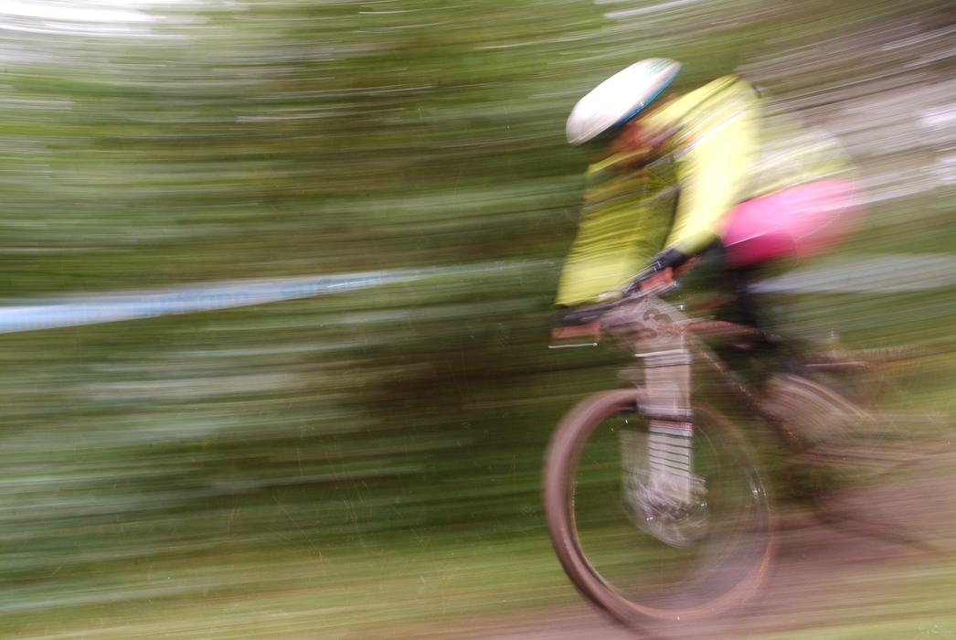 Cyclist Racing Downhill in Mountain bike Race