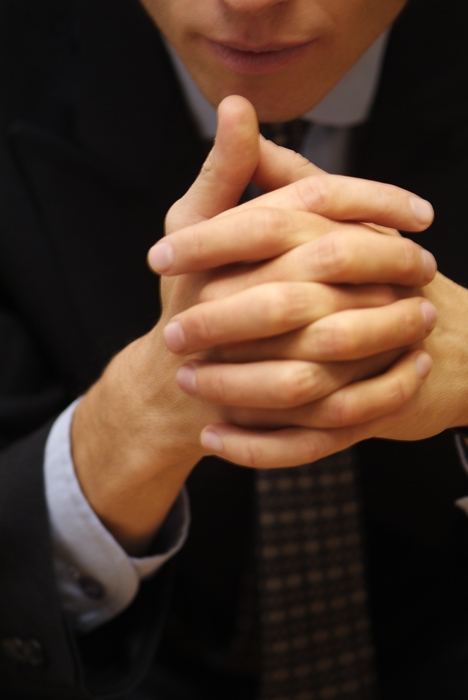 Worried Businessman Hands Clasped