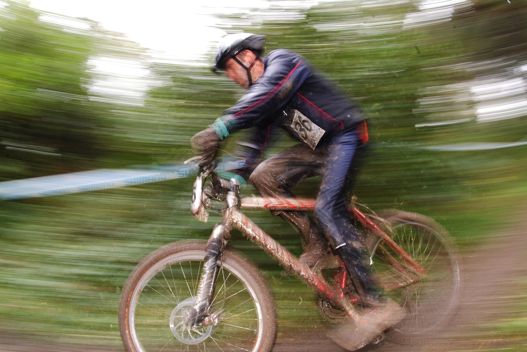 Cyclist Racing in Muddy Conditions on Mountain bike