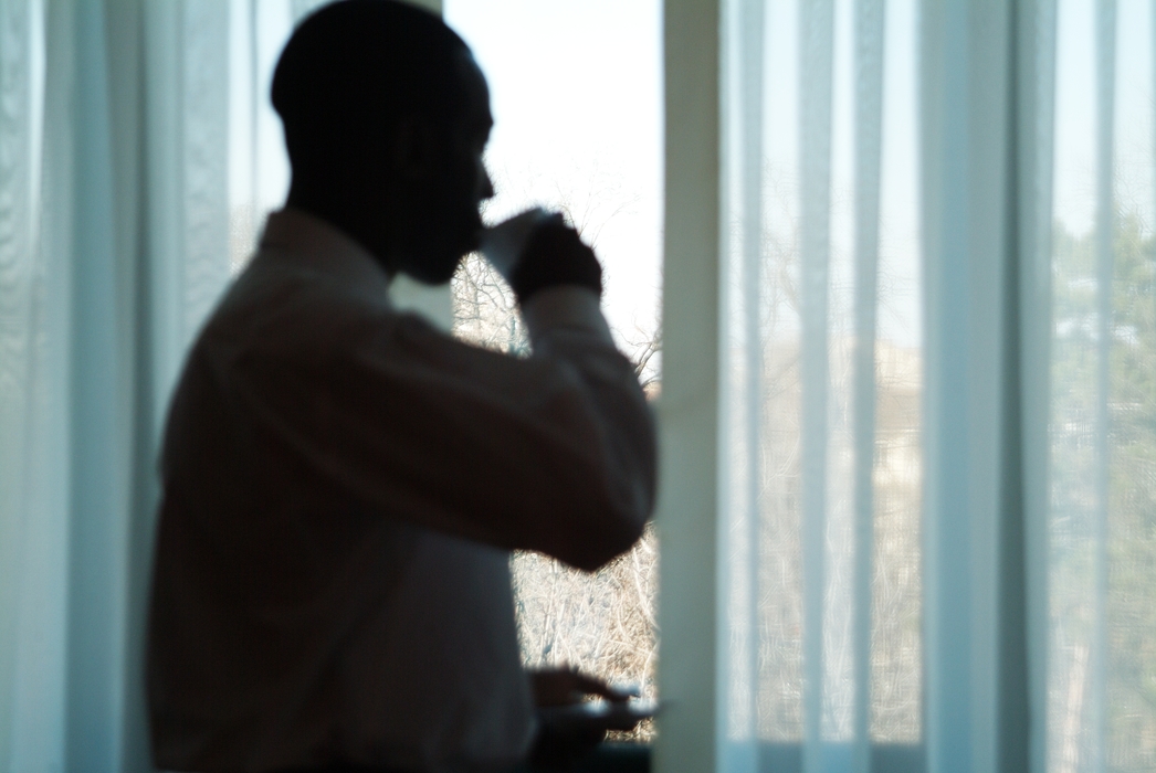 Businessman Having Coffee in Room