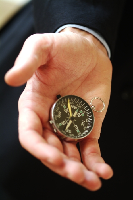 Hand Holding Navigational Compass