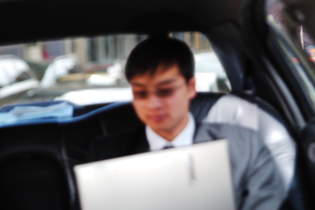 Man Working on Computer in a Limo