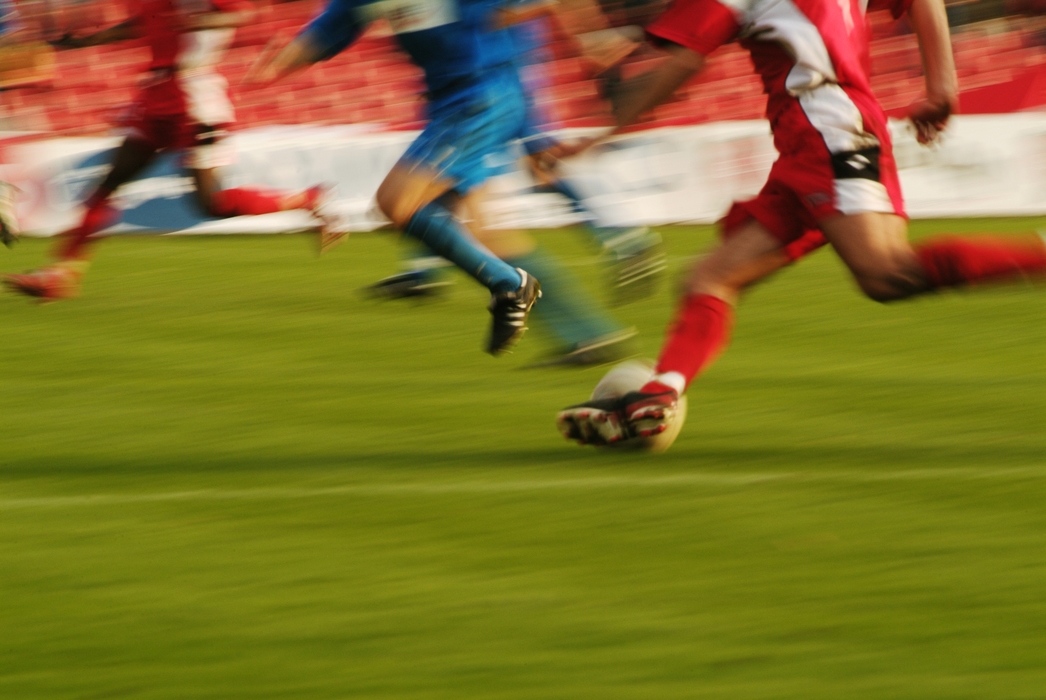 European Football: Soccer Player Running Down the Pitch