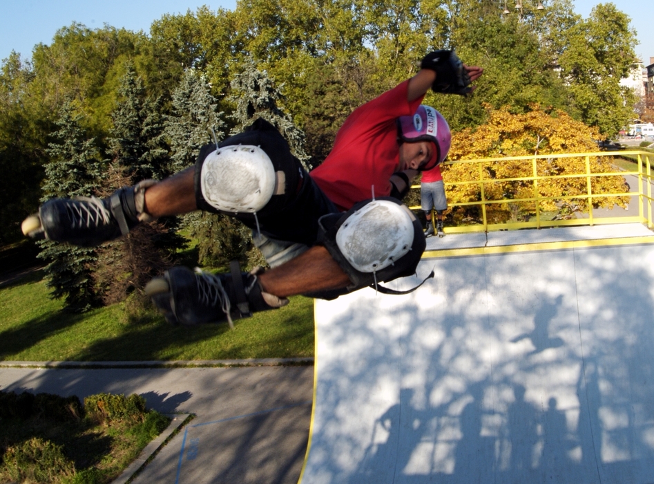 In-Line Skater Rollerblading a Half-Pipe Air