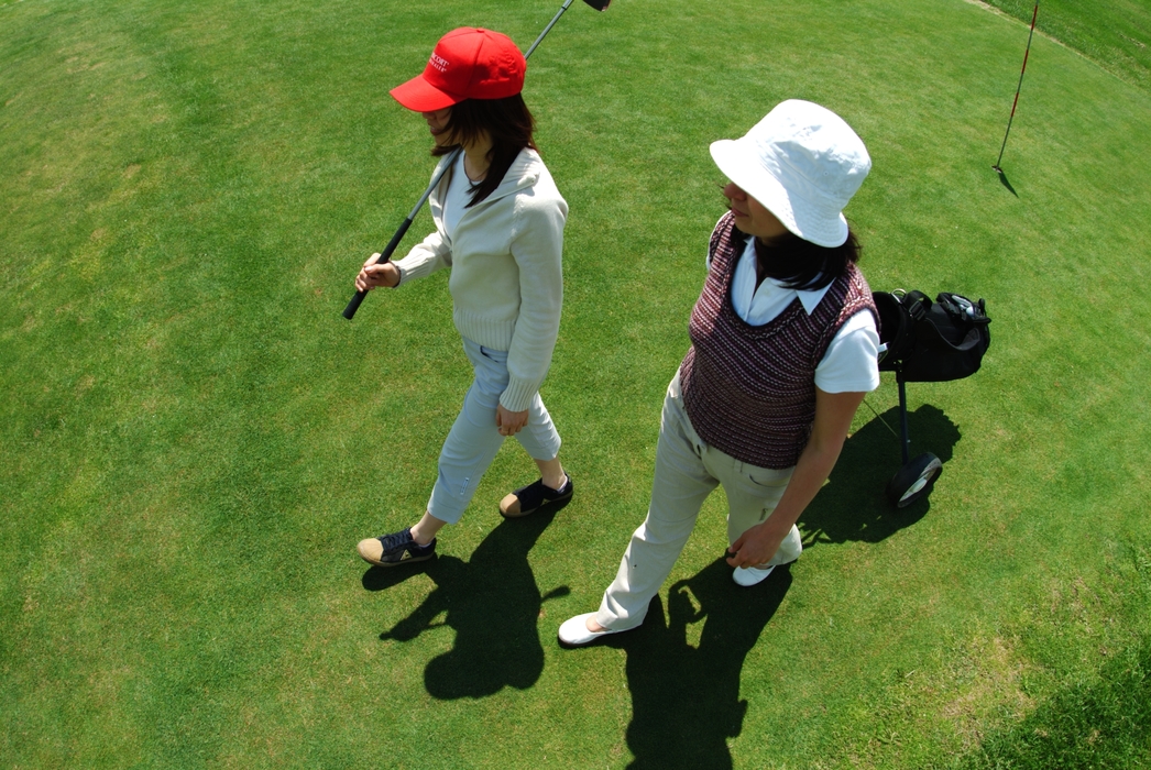 Female Golfers Walking on The Green
