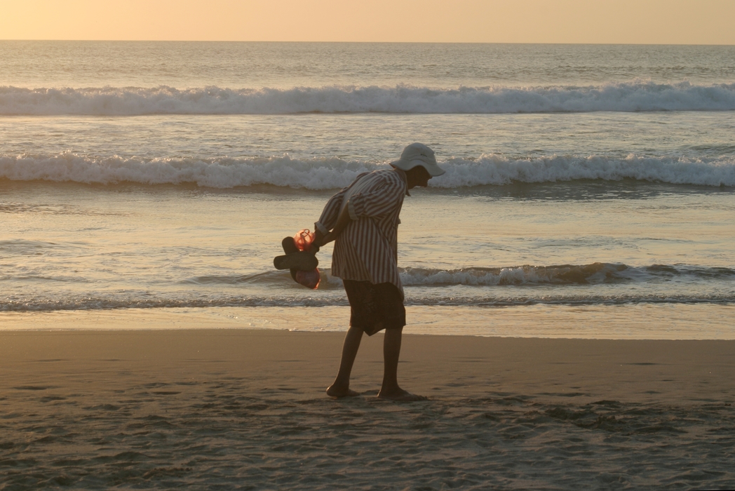 Old Man Walking on The Beach