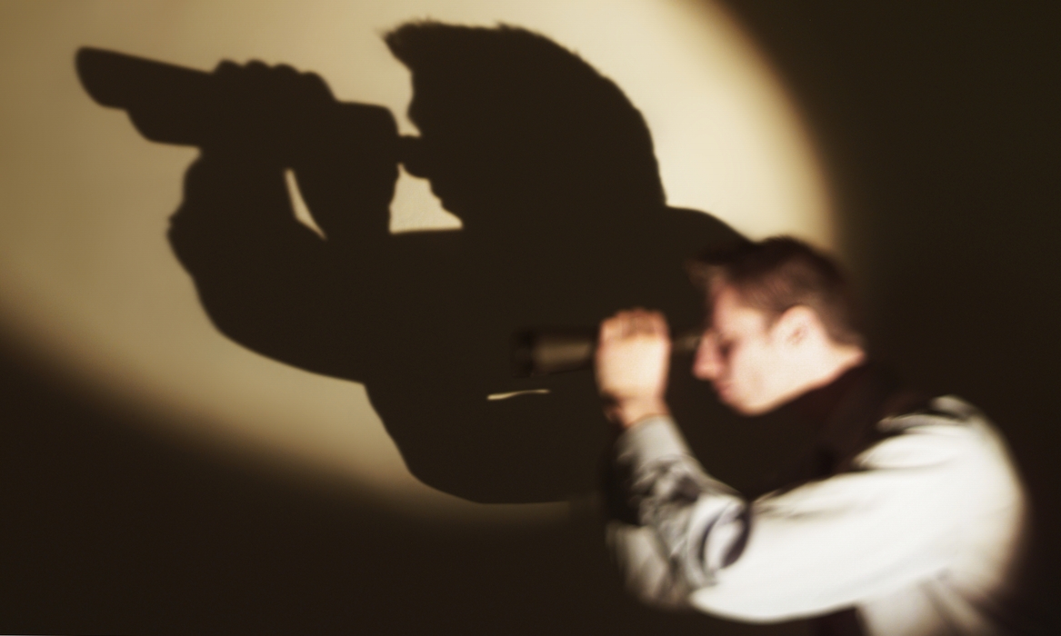 Businessman Looking Through Binoculars with Shadow
