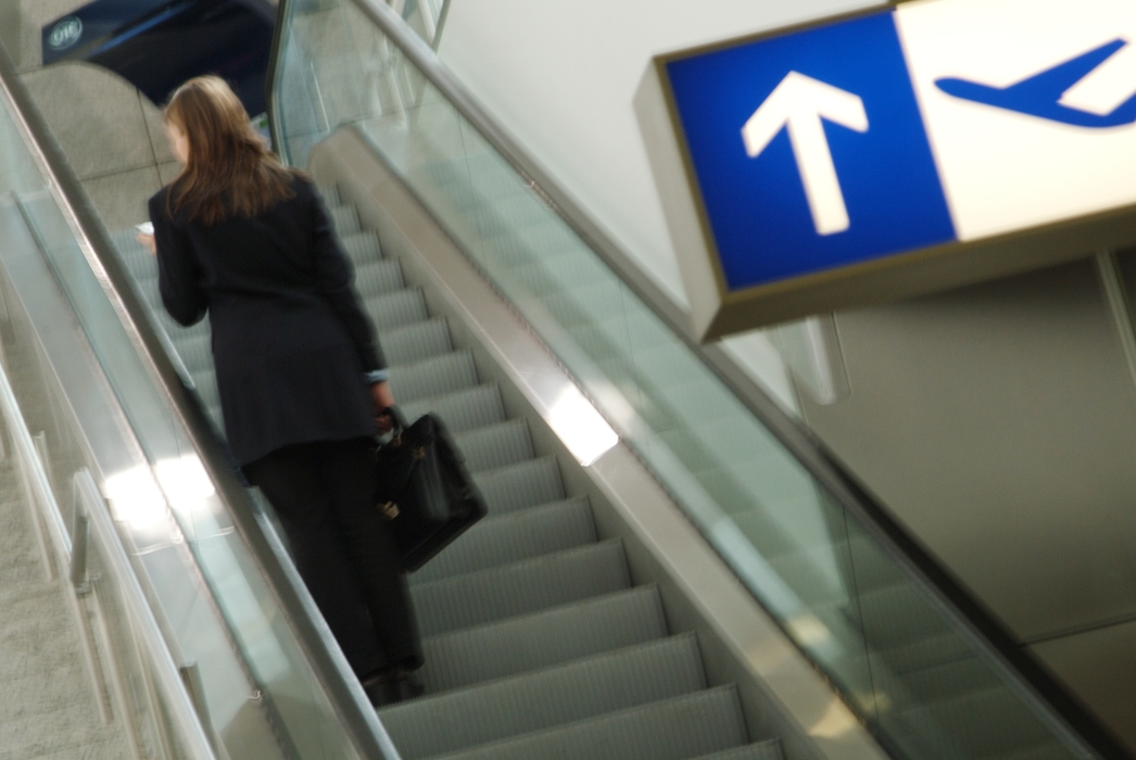 Woman on The Escalator in Airport