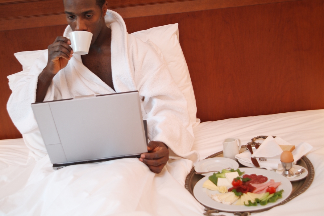 Businessman Having Breakfast in Bed