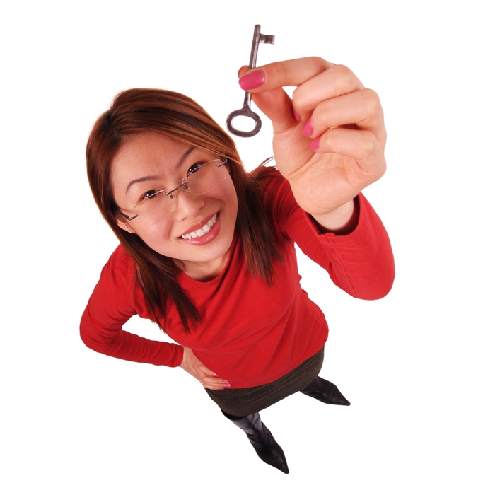 Businesswoman Holding Key to Success