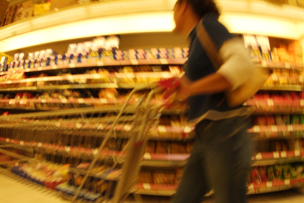 Pushing a Grocery Cart at Supermarket