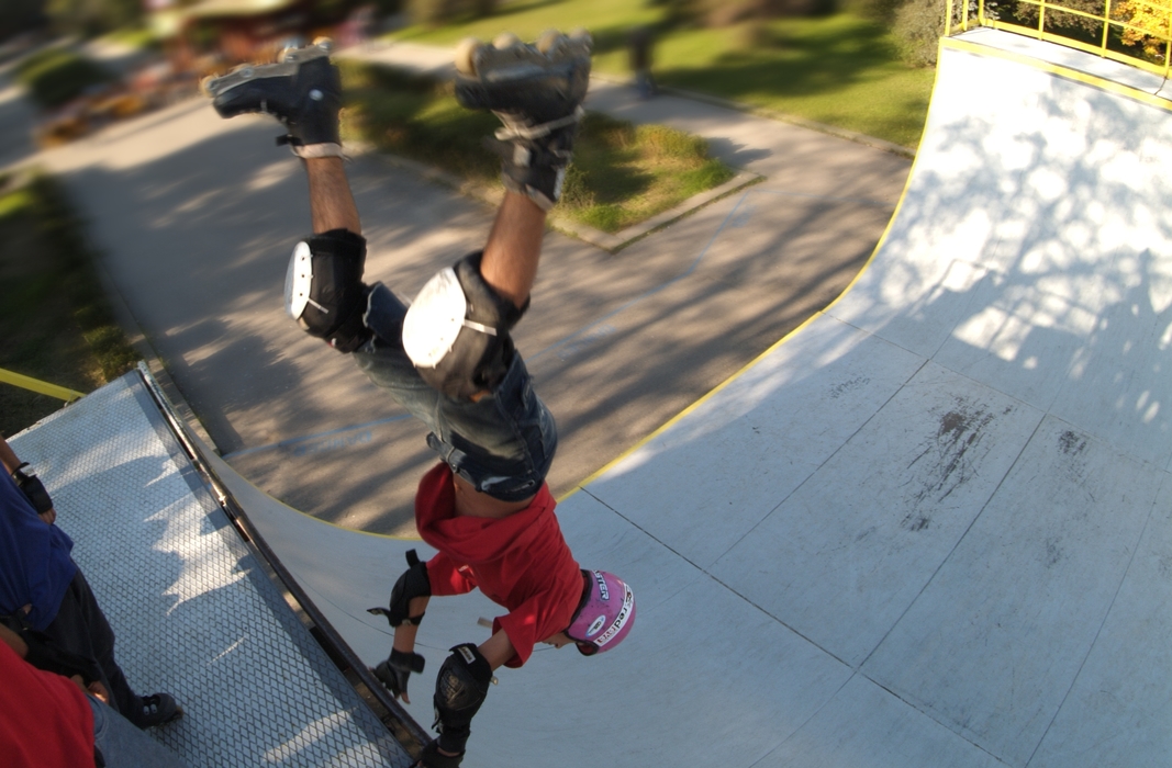 In-Line Skater Rollerblading a Half-Pipe Handstand