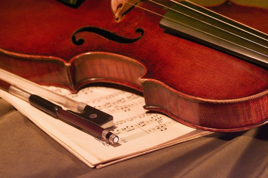 Close-Up of Violin with Bow and Sheet Music