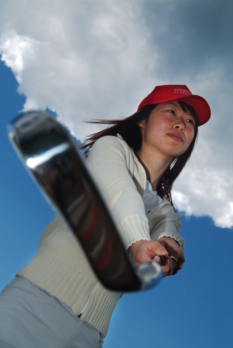 Female Golfer Lining Up Shot