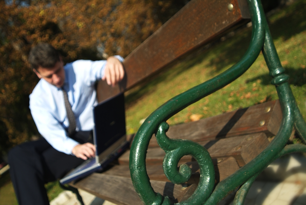 Man Working in the Park with Notebook