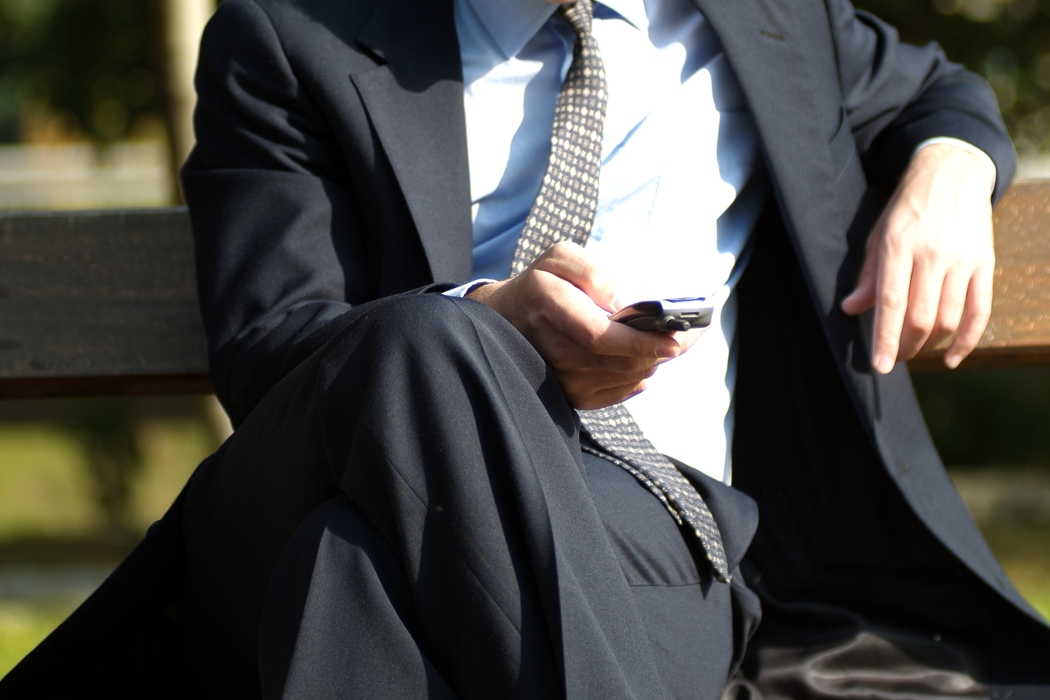 Businessman Dialing Cell Phone