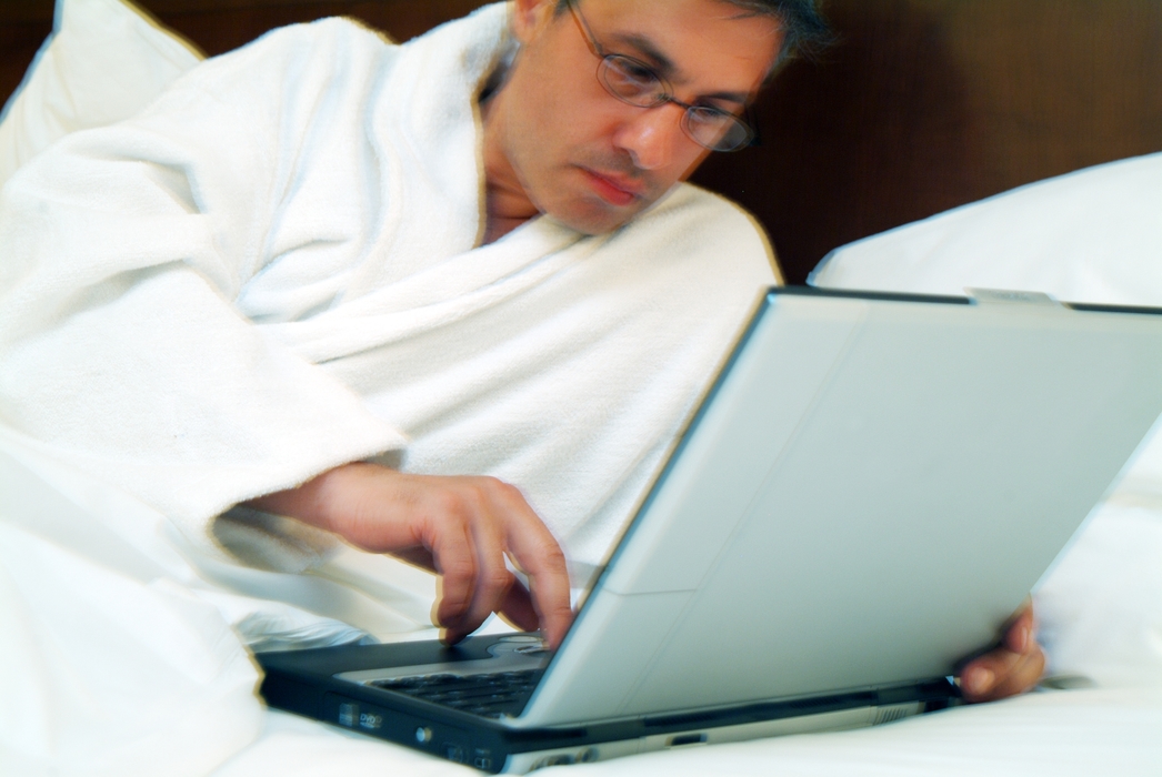 Man in Bed Working on Computer