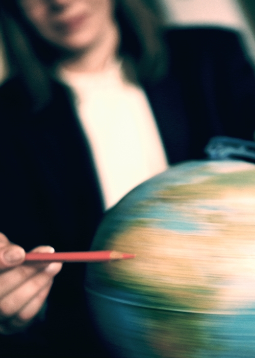 Businesswoman Spinning a Globe