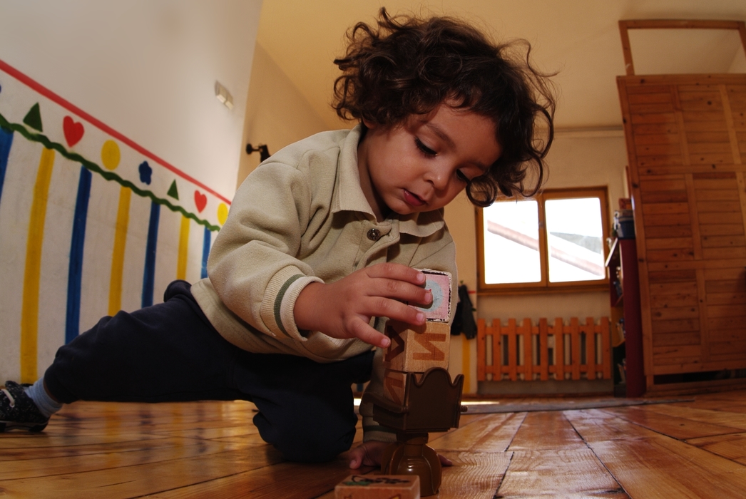 Young Boy Playing with Building Blocks
