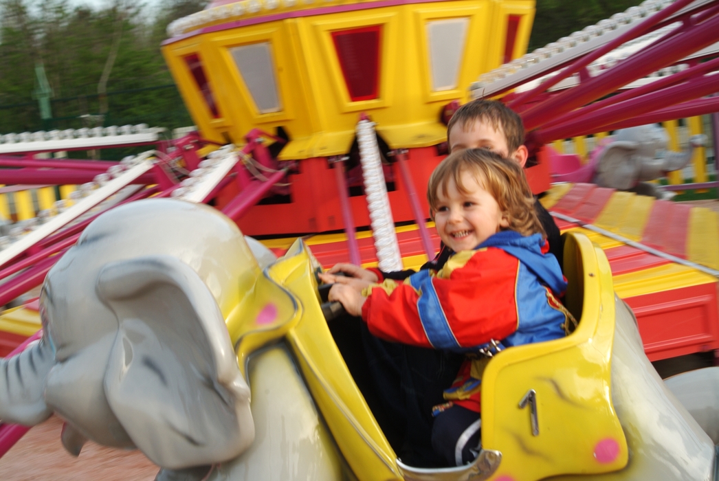 Children on a Ride At The Amusement Park