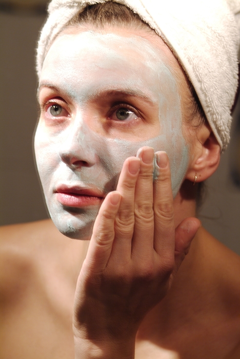 Woman Applying Cream to Her Face