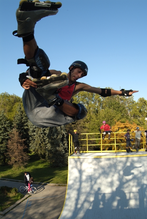 In-Line Skater Rollerblading a Half-Pipe Gets Some Air